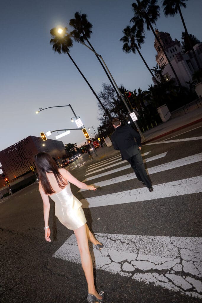 Off-camera flash portrait of couple in the archway of Beverly Hills City Hall during a nighttime engagement session