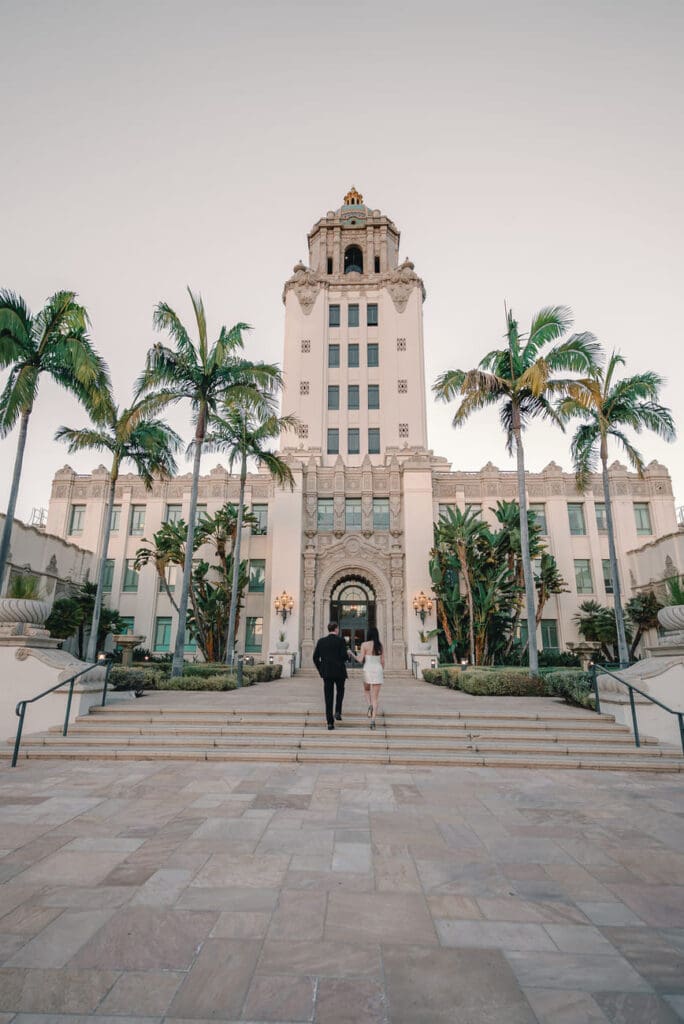 Wide shot of couple in the Palm Court area of Beverly Hills City Hall during an engagement photo session