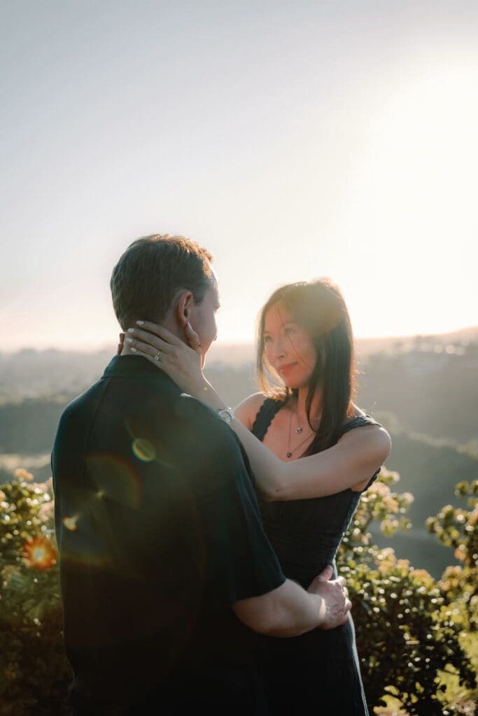 Couple posing among golden fountain grass on a Beverly Hills hillside during an engagement photo session