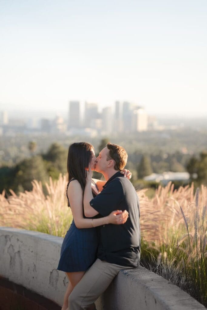 Silhouette of couple against the LA skyline during golden hour engagement photos in the Beverly Hills hills