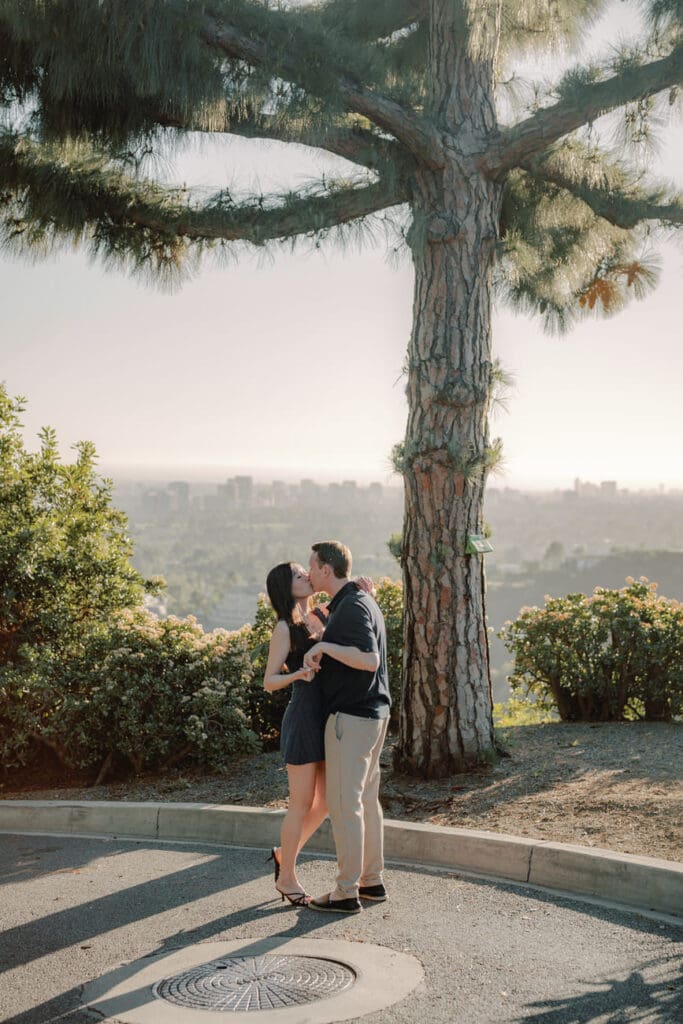 Couple standing at a scenic overlook in the Trousdale Estates hills during a Beverly Hills engagement session