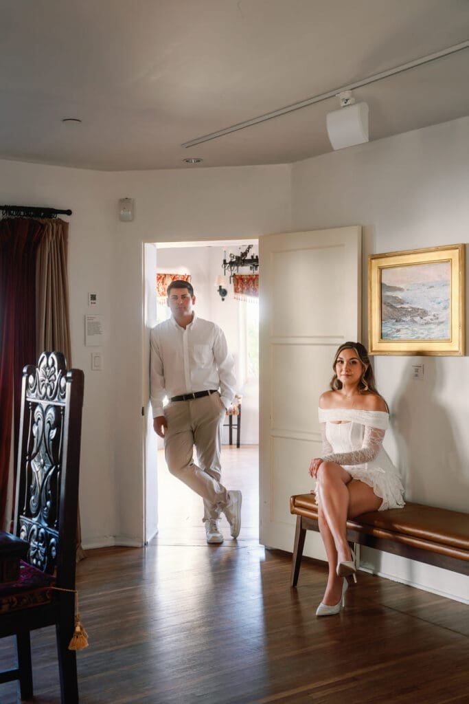 Couple posing in the bridal suite doorway during their Casa Romantica engagement photos in San Clemente.