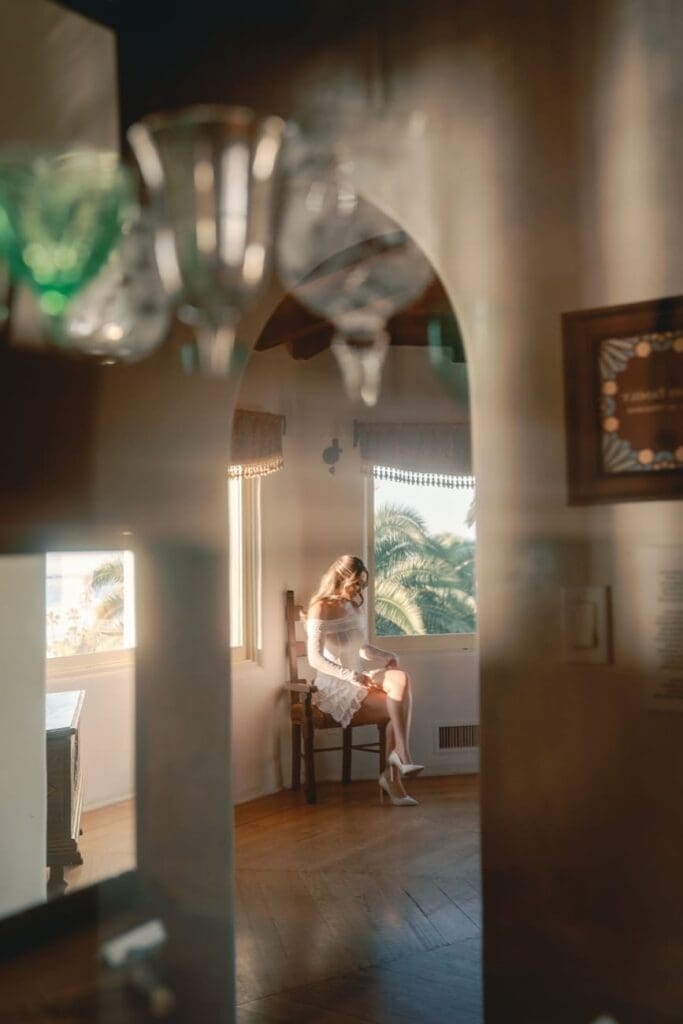 Editorial reflection portrait of a couple inside the museum rooms during Casa Romantica engagement photos.