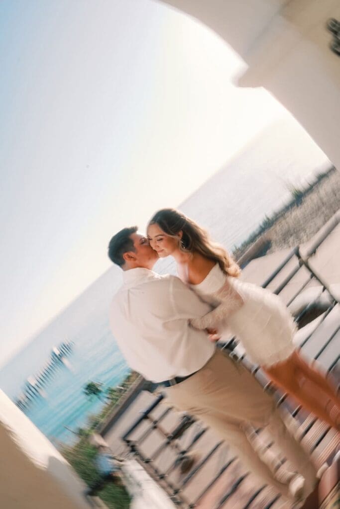 Motion blur of a couple walking through the main salon arches during Casa Romantica engagement photos in San Clemente, California.