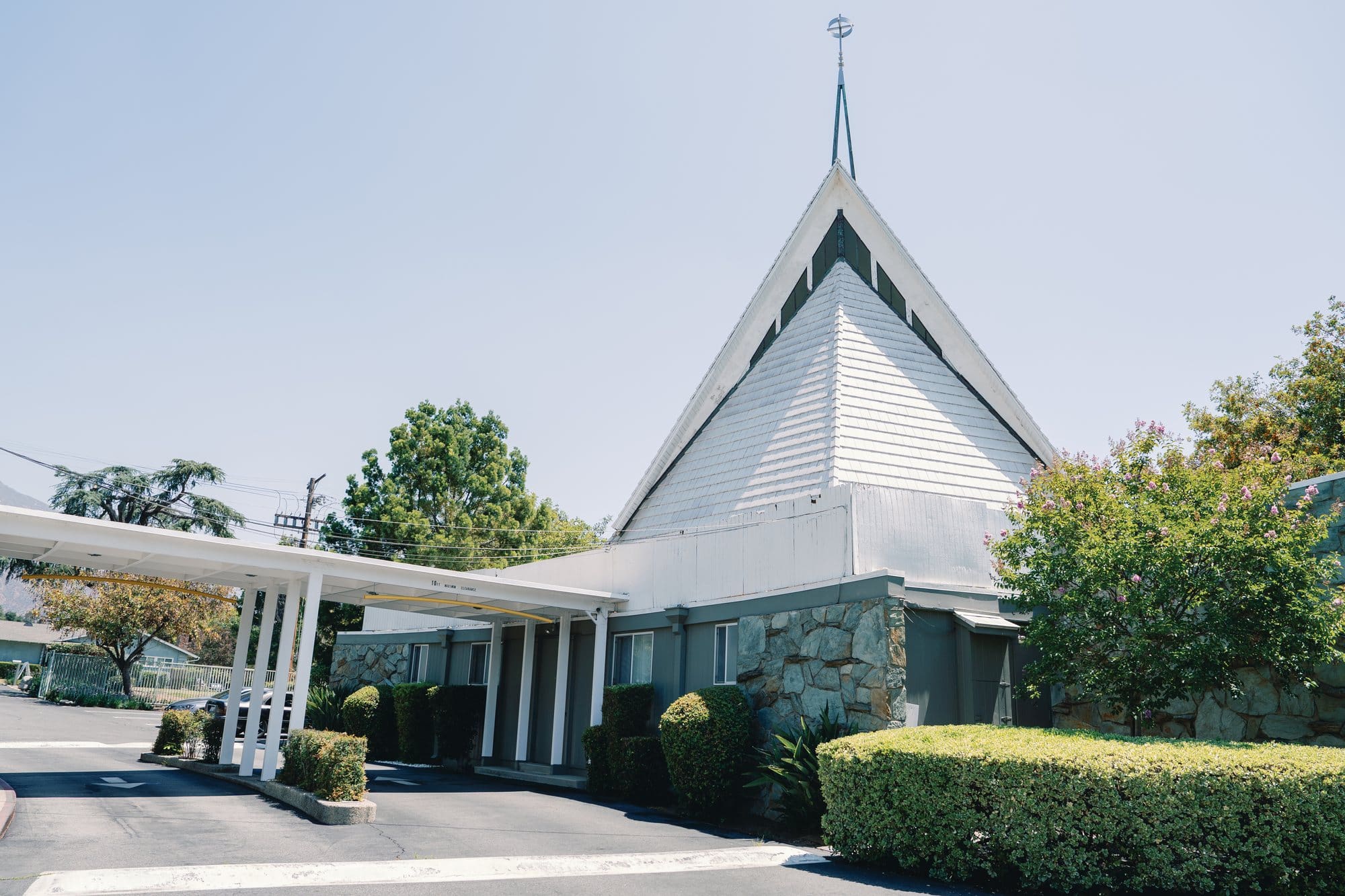 The church entrance and pitched roof stand beneath a clear sky at The Santa Anita Church in Arcadia, California.