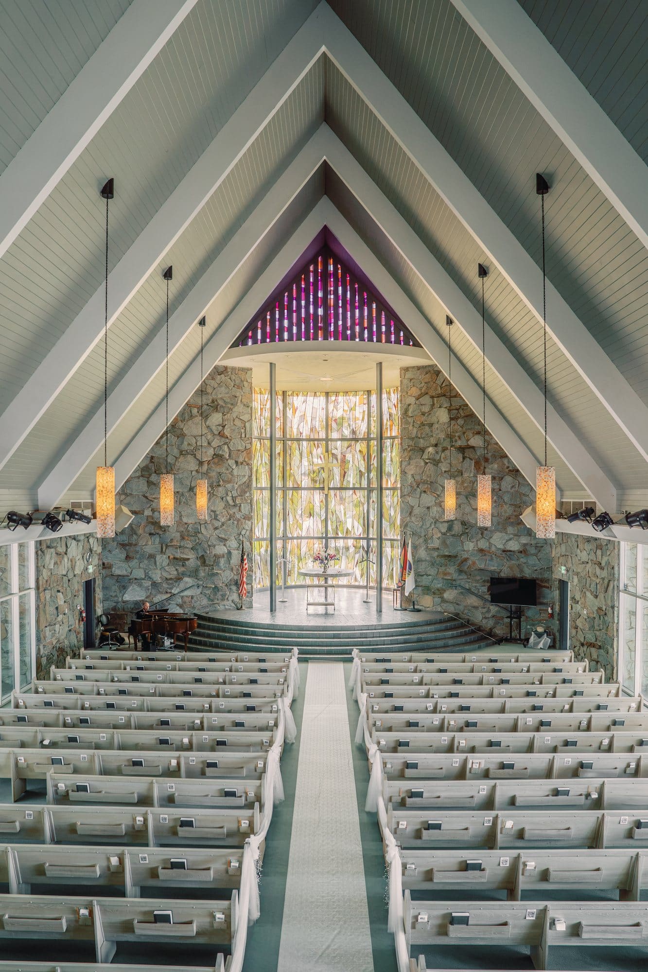 The empty sanctuary aisle leads toward the stained glass Tower of Light before a Santa Anita Church wedding in Arcadia, California.
